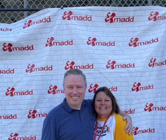MADD banner on fence