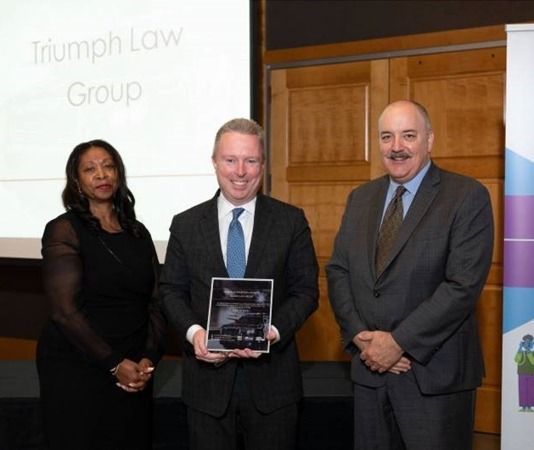 Triumph Law recieving an award