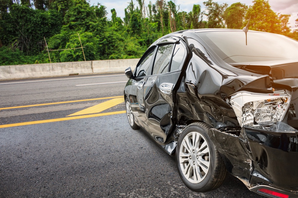 A Damaged Car In The Road Following A Hit And Run Accident