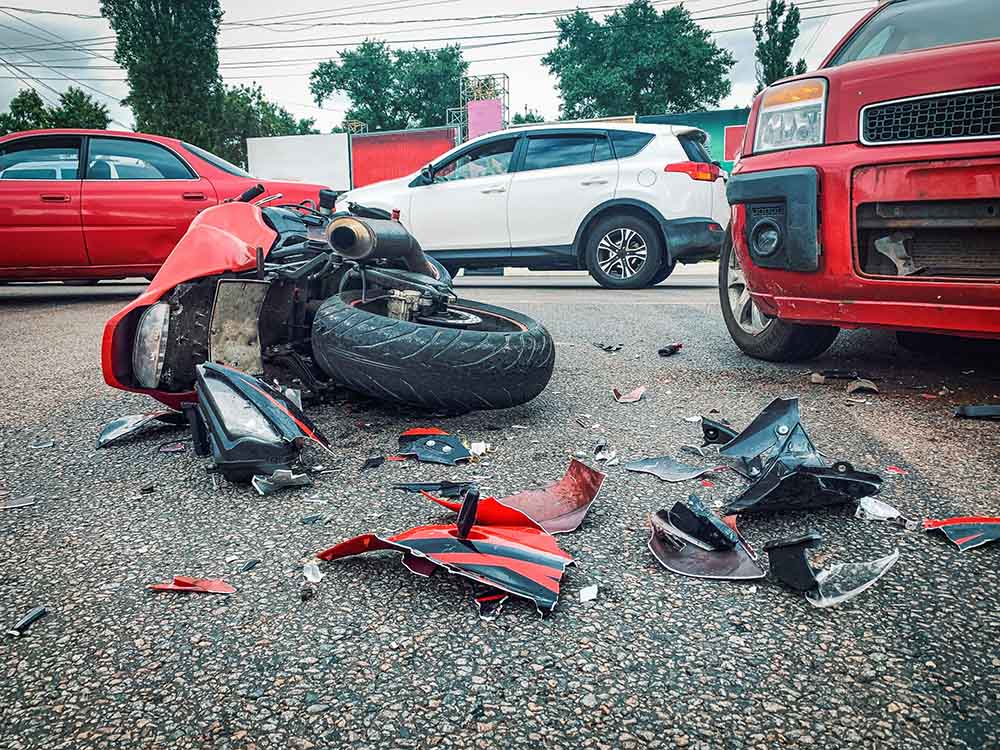 a-wrecked-motorcycle-in-the-road-after-a-collision-with-a-car