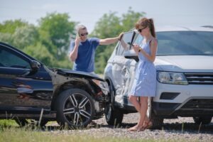 woman-and-man-exchanging-info-after-car-and-truck-crash