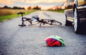 car with helmet and bicycle on ground